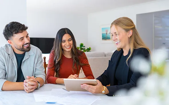 Business professionals in a discussion, symbolizing expert private lending services and real estate investment solutions.