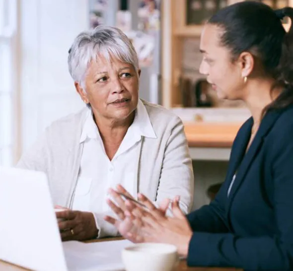 Senior woman consulting with a financial advisor, showcasing personalized private lending solutions.